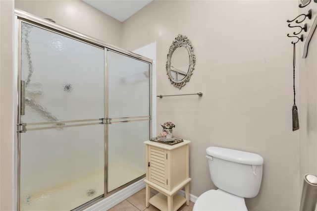 bathroom with walk in shower, toilet, and tile patterned flooring