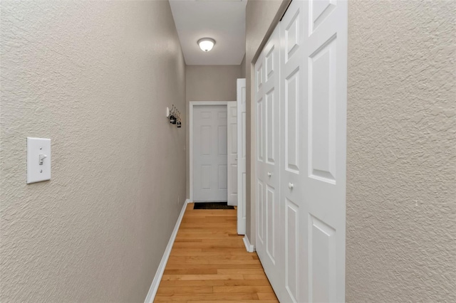 hallway with light hardwood / wood-style flooring