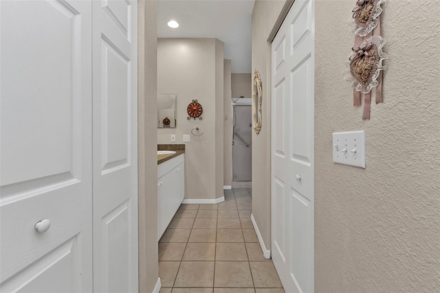 hall featuring light tile patterned floors