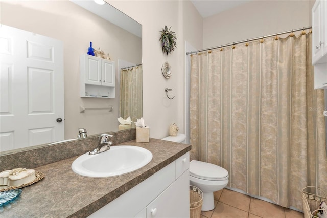 bathroom with vanity, toilet, and tile patterned flooring