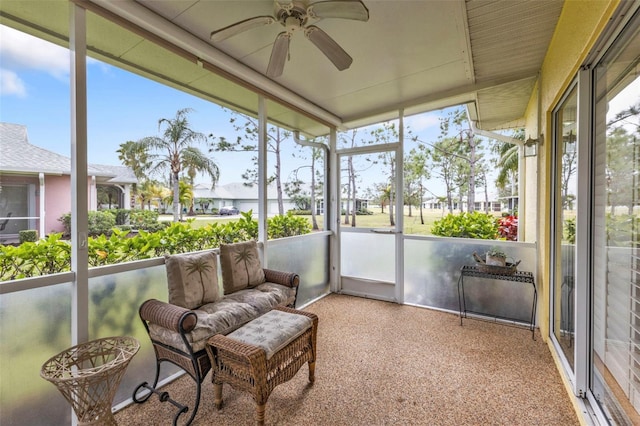 sunroom featuring ceiling fan and a wealth of natural light