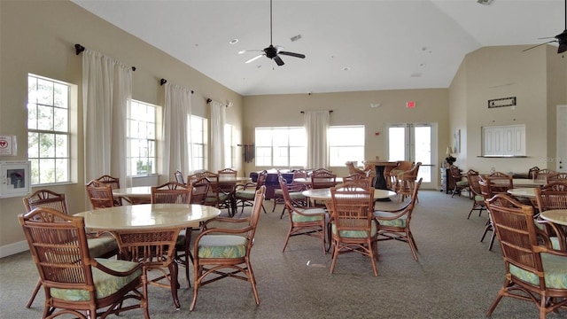 carpeted dining room with vaulted ceiling and ceiling fan