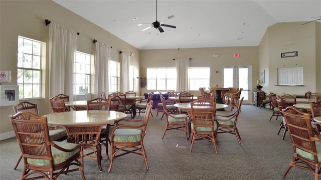 carpeted dining room featuring vaulted ceiling and ceiling fan