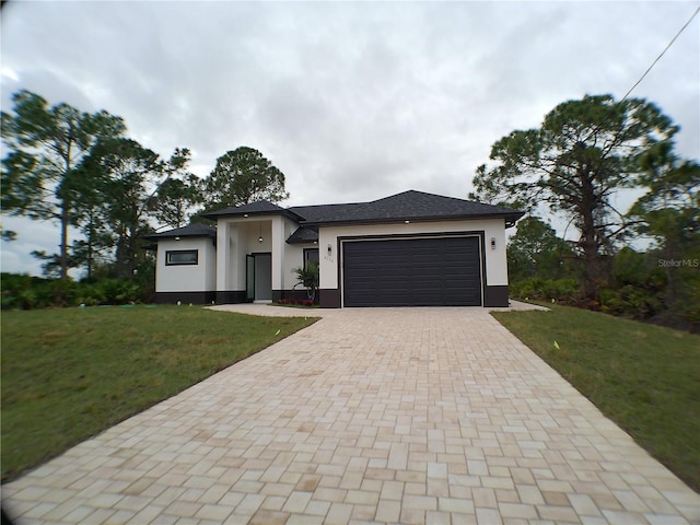 view of front of house with a garage and a front yard