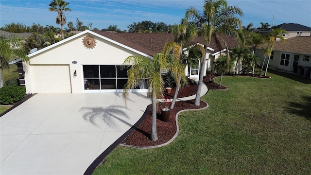 ranch-style house featuring a garage and a front lawn