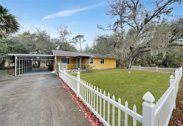 view of front of home with a front lawn and a carport