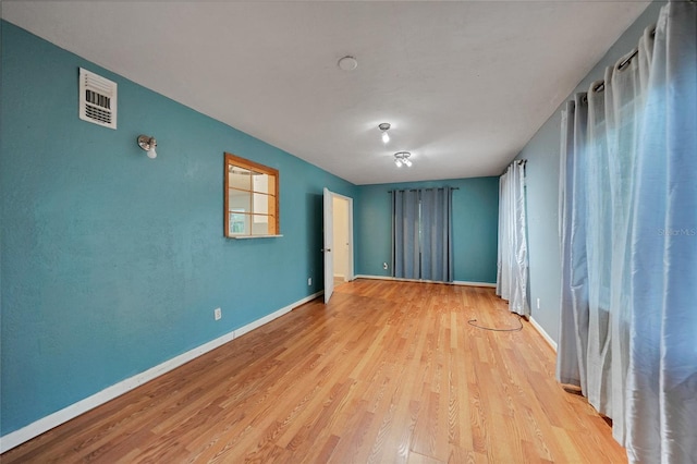 spare room featuring light hardwood / wood-style floors