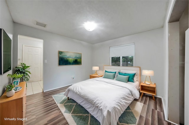 bedroom with hardwood / wood-style floors