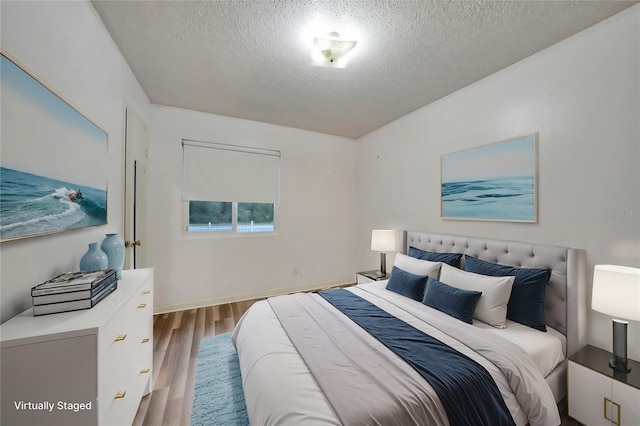 bedroom featuring hardwood / wood-style floors and a textured ceiling