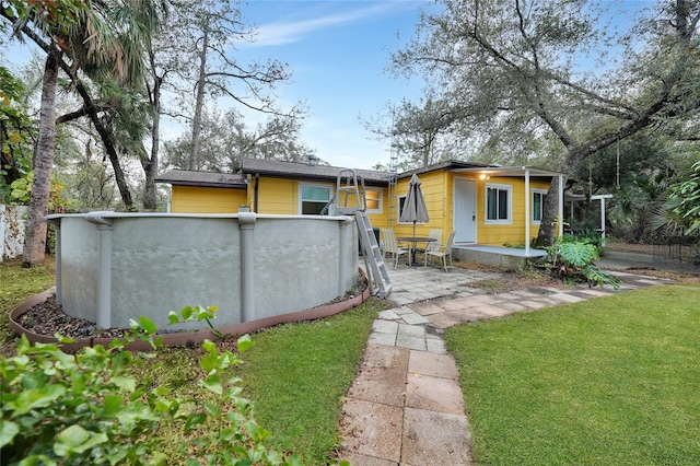 rear view of house featuring a yard