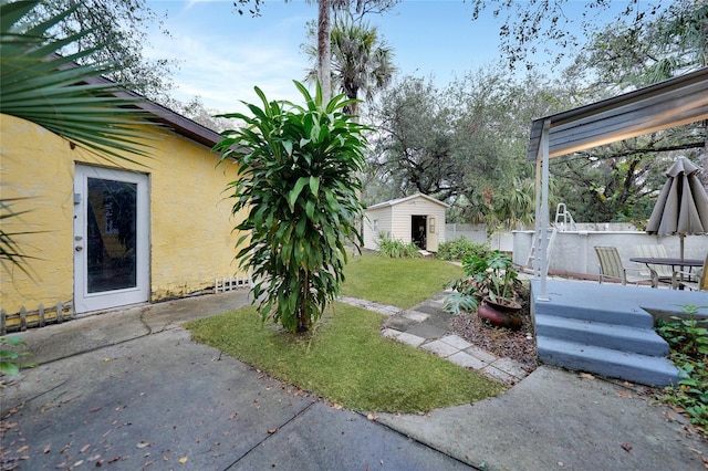 view of yard with a patio and a shed