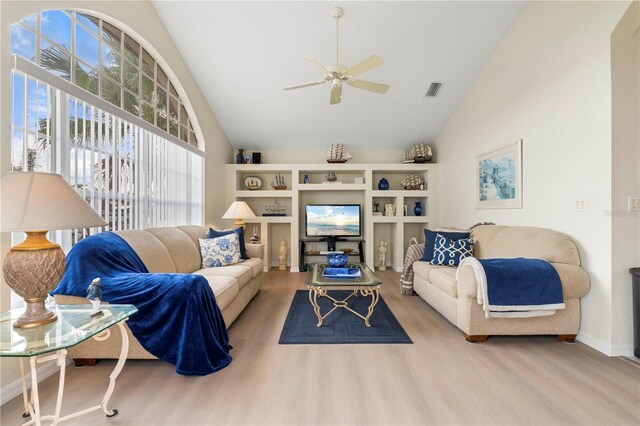 living room with ceiling fan, light hardwood / wood-style floors, and lofted ceiling