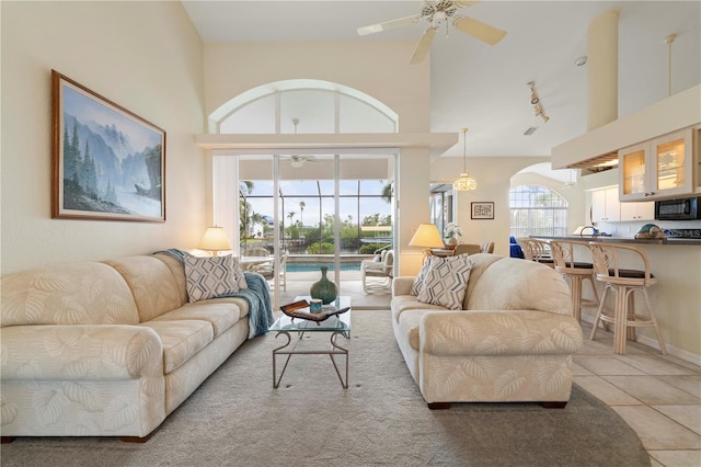 tiled living room with ceiling fan