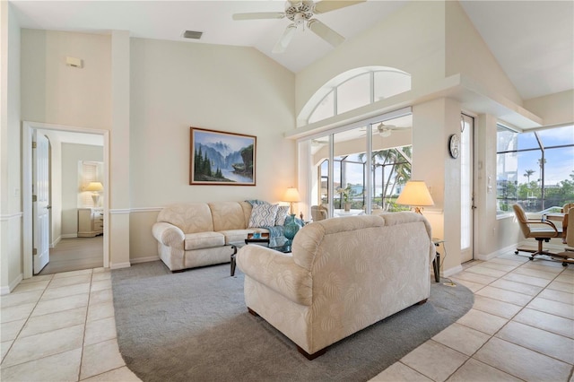 living room with ceiling fan, high vaulted ceiling, and light tile patterned floors