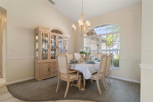 carpeted dining room with a chandelier and vaulted ceiling