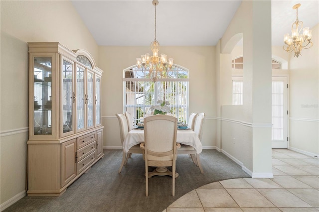 tiled dining room with a notable chandelier