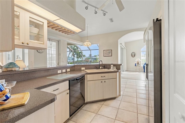 kitchen with black dishwasher, sink, stainless steel fridge, ceiling fan, and light tile patterned floors