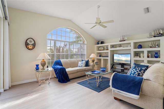 living room featuring ceiling fan, hardwood / wood-style floors, and vaulted ceiling