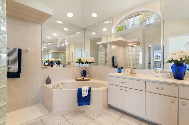 bathroom with plus walk in shower, tile patterned flooring, lofted ceiling, and vanity