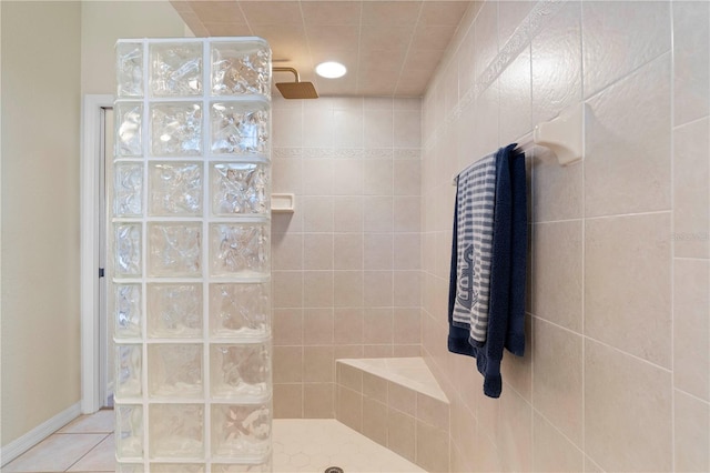 bathroom featuring a tile shower and tile patterned flooring