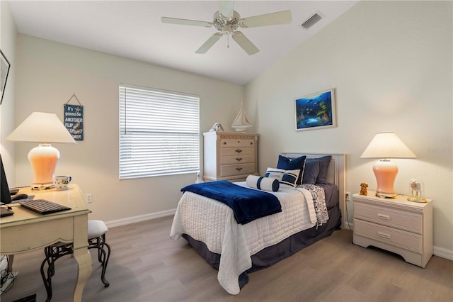 bedroom featuring light wood-type flooring, ceiling fan, and lofted ceiling