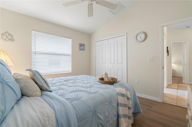 bedroom featuring ceiling fan, hardwood / wood-style floors, a closet, and vaulted ceiling