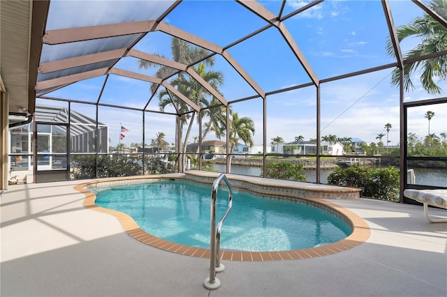 view of swimming pool featuring glass enclosure, a water view, and a patio