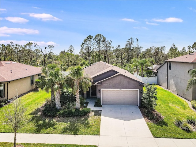 view of front of property with a garage and a front yard