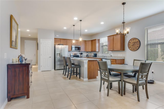 dining space featuring a chandelier and light tile patterned floors