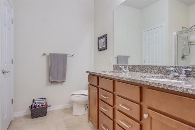 bathroom with toilet, tile patterned flooring, a shower with shower door, and vanity