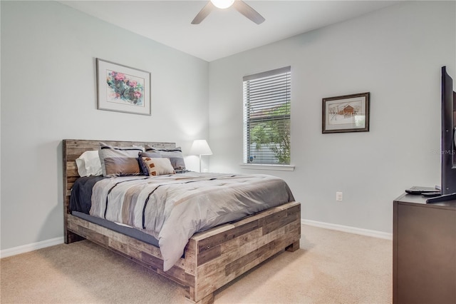 bedroom featuring light colored carpet and ceiling fan