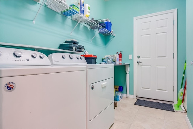 laundry area featuring light tile patterned floors and washer and clothes dryer