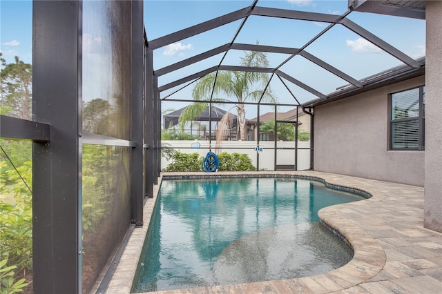 view of pool featuring a patio and glass enclosure