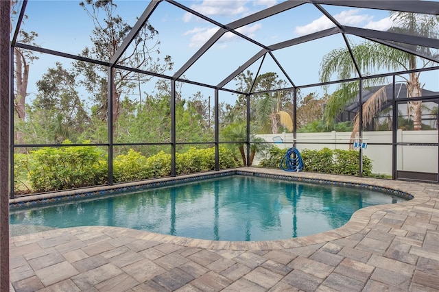 view of pool featuring a patio and glass enclosure