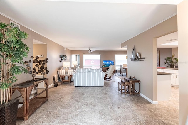 living room with ceiling fan and ornamental molding