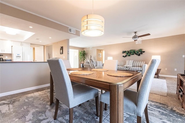 dining space with ceiling fan and tile patterned floors