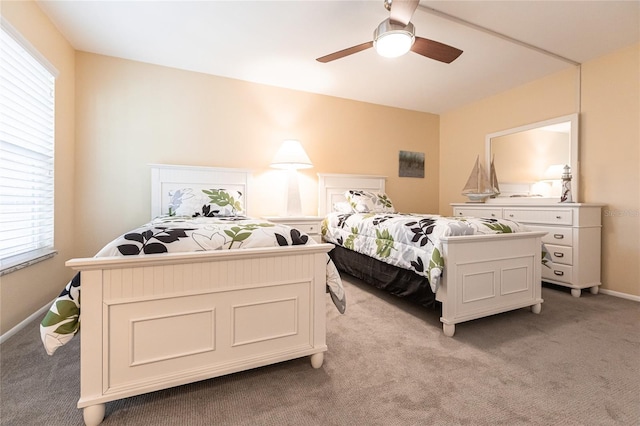 carpeted bedroom featuring ceiling fan and multiple windows