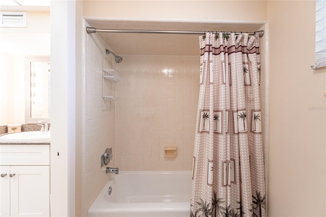 bathroom featuring vanity and shower / bathtub combination with curtain