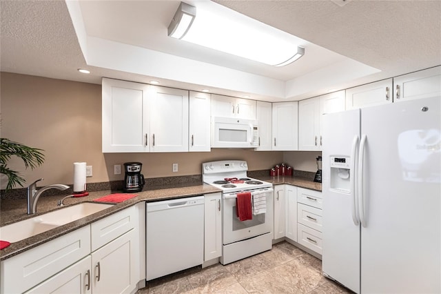 1 Colony Point Dr Unit A19, Punta Gorda, FL 33950 - kitchen featuring white appliances, white cabinets, a tray ceiling, a textured ceiling, and a sink