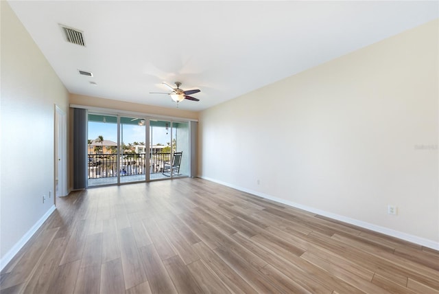 spare room with ceiling fan and light wood-type flooring