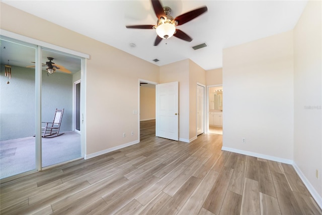 unfurnished bedroom with ensuite bathroom, ceiling fan, and light hardwood / wood-style flooring