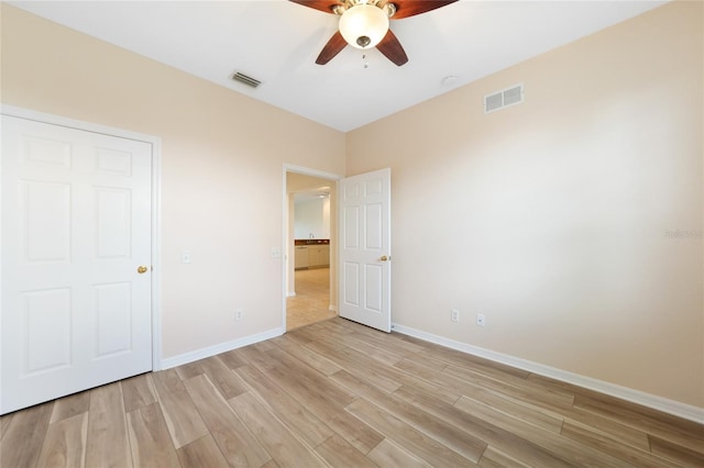 unfurnished bedroom featuring ceiling fan and light hardwood / wood-style flooring