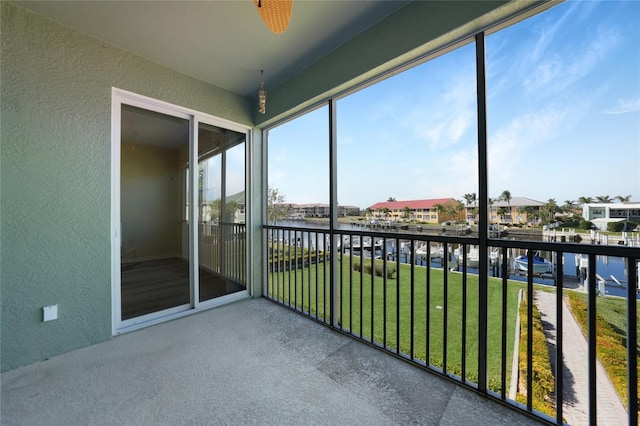 unfurnished sunroom featuring a water view