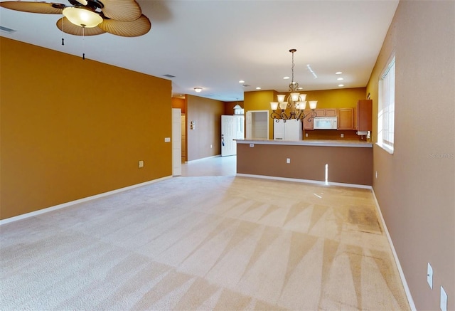 unfurnished living room featuring light colored carpet and ceiling fan with notable chandelier