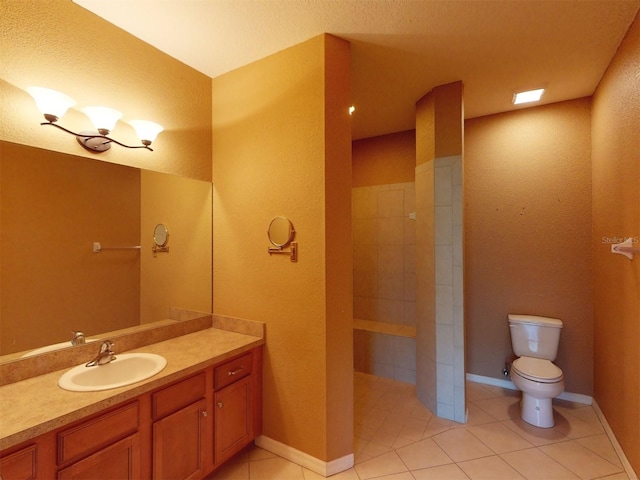 bathroom with tile patterned flooring, vanity, and toilet