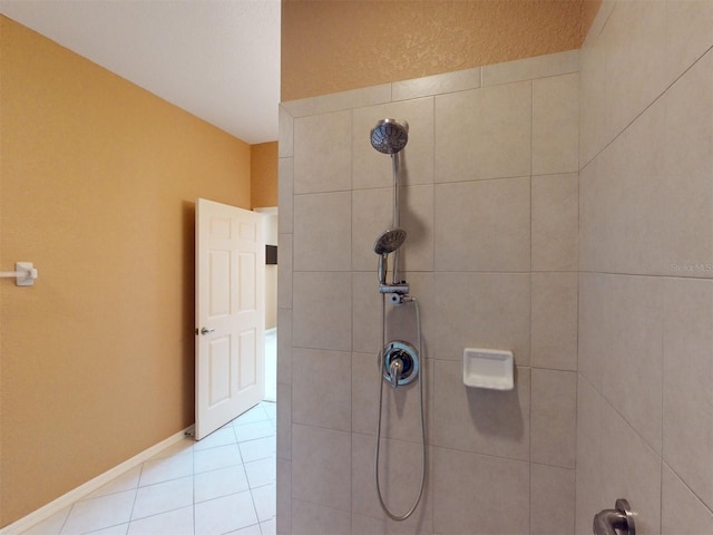 bathroom featuring a tile shower and tile patterned flooring