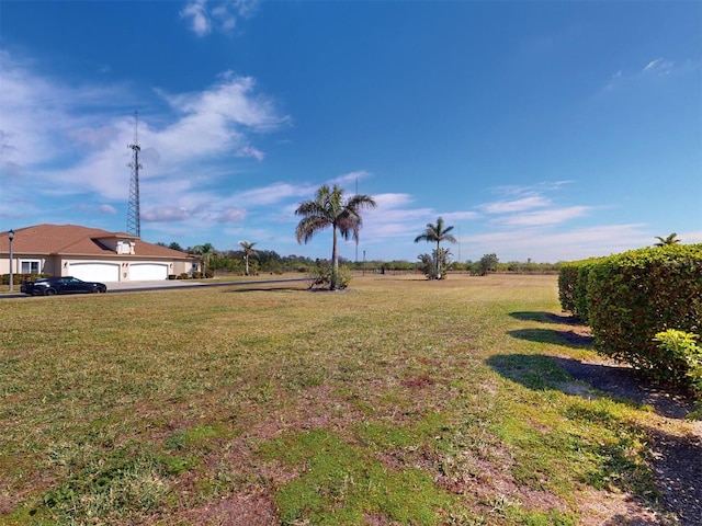 view of yard featuring a garage and a rural view