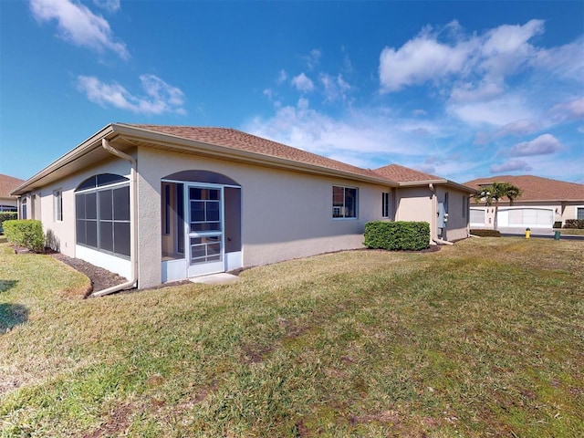 view of side of property with a lawn