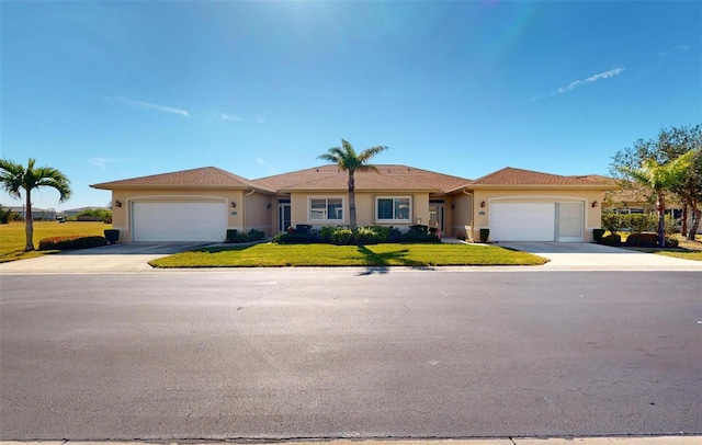 single story home with a garage and a front yard