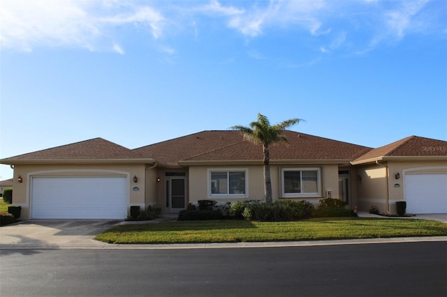 ranch-style home featuring a garage and a front yard